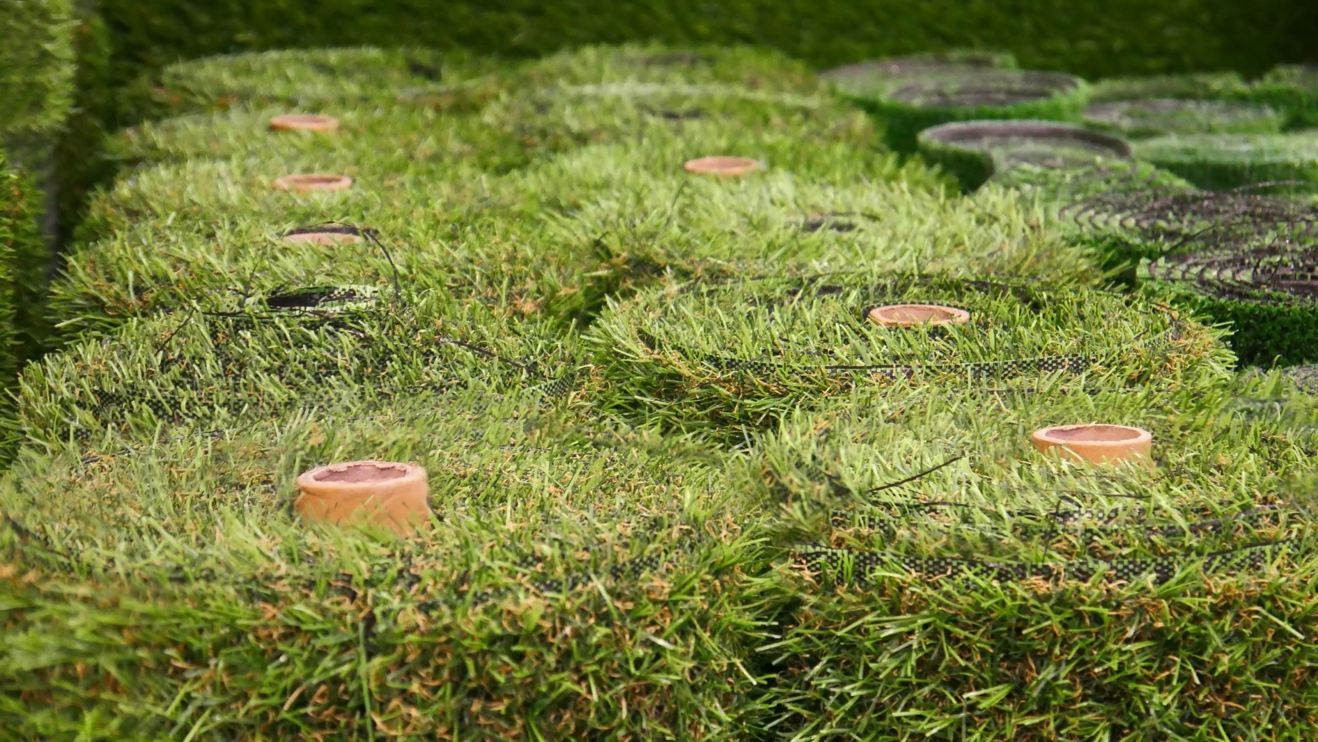 Synthetic grass turf rolls for landscaping, sports, and play areas.