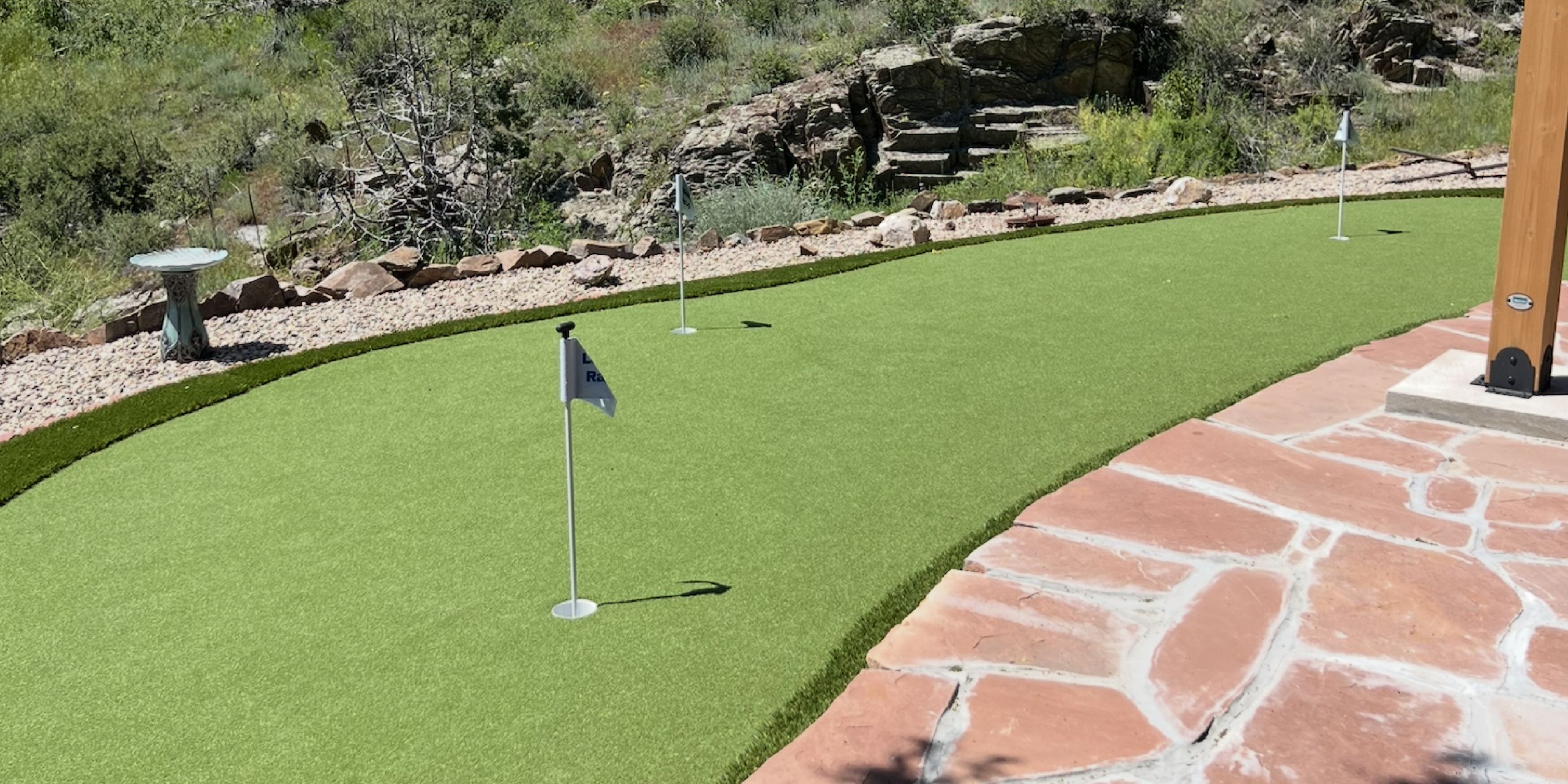 Artificial grass putting green with flags in Fort Collins backyard.
